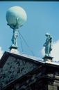 Great Atlas statue high on top of one of Amsterdams rooftops.